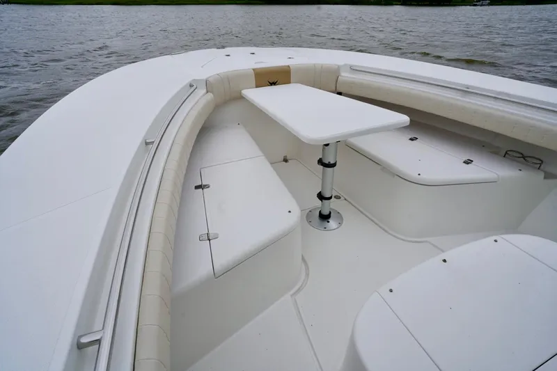 Slide: The Image of 2015 Southport 29 FE boat interior with seating and table on calm water. - 28