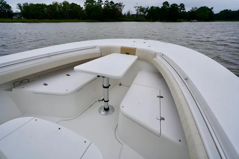 Slide: The Image of 2015 Southport 29 FE boat interior with seating and table on calm water. - 29