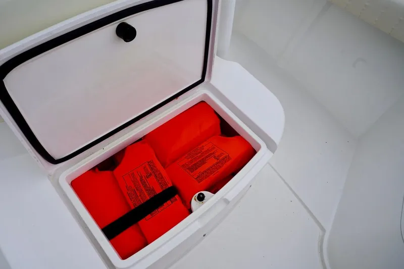 Slide: The Image of Storage compartment with life jackets on a 2015 Southport 29 FE boat. - 31