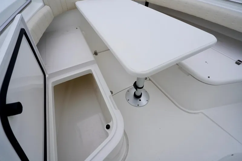Slide: The Image of 2015 Southport 29 FE boat interior with storage compartment and table. - 32