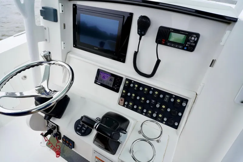 Slide: The Image of Control panel of 2015 Southport 29 FE boat with steering wheel and electronics. - 33
