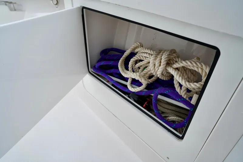 Slide: The Image of Storage compartment with ropes on a 2015 Southport 29 FE boat. - 34