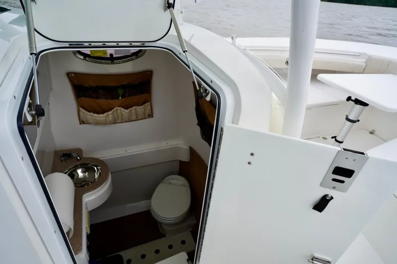 Slide: The Image of 2015 Southport 29 FE boat interior with compact bathroom and sink. - 36