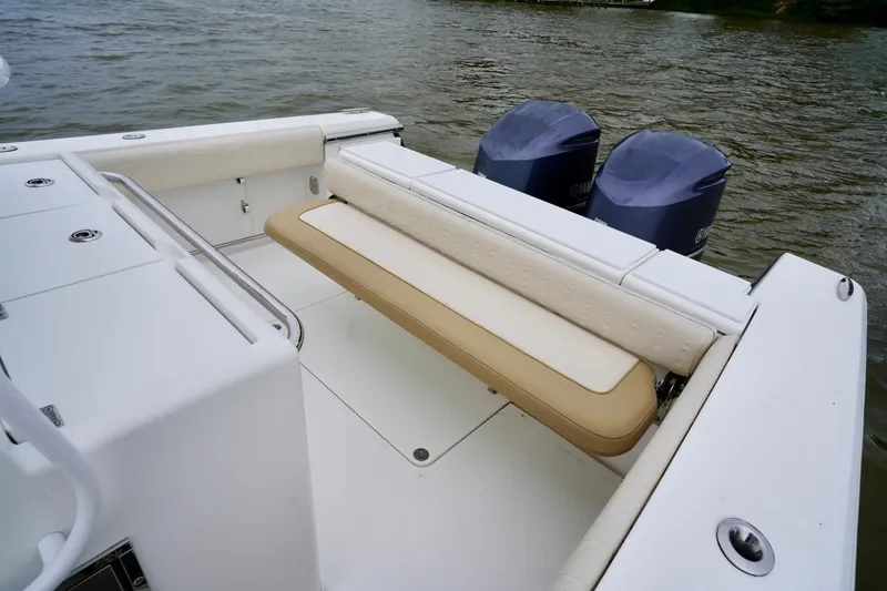 Slide: The Image of 2015 Southport 29 FE boat with dual engines and cushioned seating on the water. - 39
