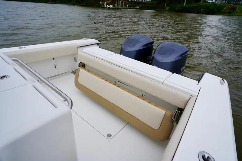 Slide: The Image of 2015 Southport 29 FE boat with dual engines and foldable seating on a calm waterway. - 40