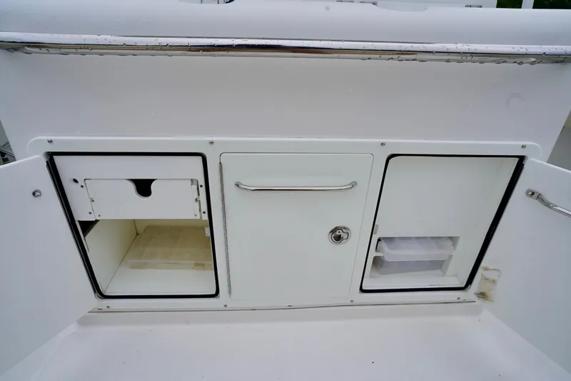 Slide: The Image of Storage compartments on a 2015 Southport 29 FE boat, featuring sleek white design. - 45