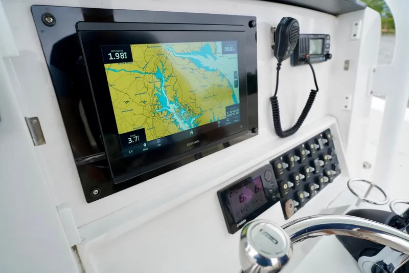 Slide: The Image of Control panel of 2015 Southport 29 FE boat with navigation display and radio. - 47