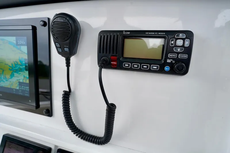 Slide: The Image of Control panel of 2015 Southport 29 FE boat with VHF marine radio and display screen. - 51