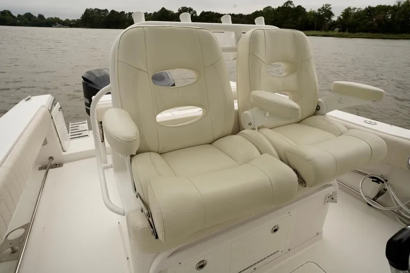 Slide: The Image of Luxurious seating on 2015 Southport 29 FE boat, featuring plush white leather chairs. - 52