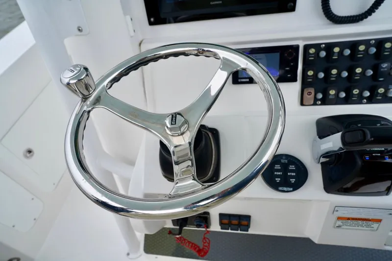 Slide: The Image of Steering wheel and controls of 2015 Southport 29 FE boat cockpit. - 55