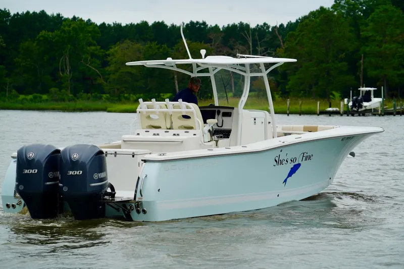 Slide: The Image of 2015 Southport 29 FE boat with dual Yamaha 300 engines on a scenic waterway. - 6