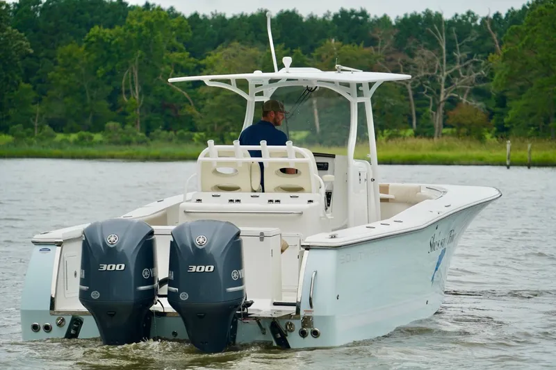 Slide: The Image of 2015 Southport 29 FE boat with dual Yamaha 300 engines on a calm river. - 8