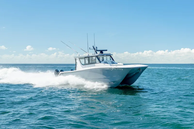 Slide: The Image of 2025 Invincible 46 Pilothouse boat cruising on open water. - 1