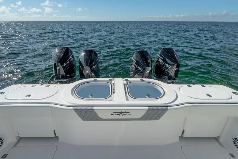 Slide: The Image of 2025 Invincible 46 Pilothouse boat with quad outboard engines on open water. - 17