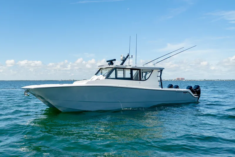 Slide: The Image of 2025 Invincible 46 Pilothouse boat cruising on open water. - 5