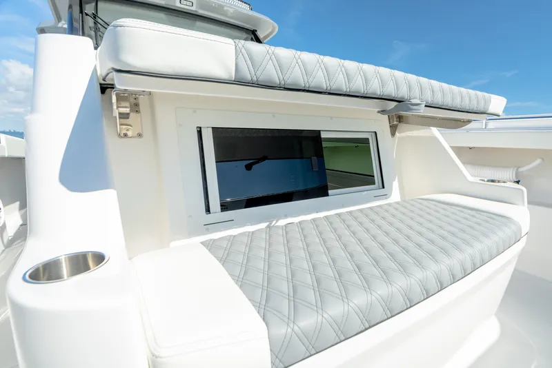 Slide: The Image of Invincible 46 Pilothouse 2025 boat with cushioned seating and window. - 11