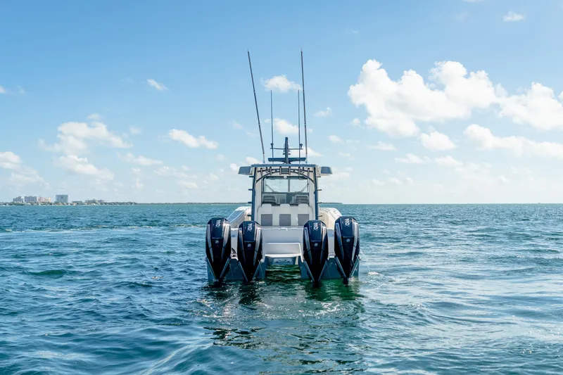 Slide: The Image of 2025 Invincible 46 Pilothouse boat with multiple outboard engines on open water. - 8