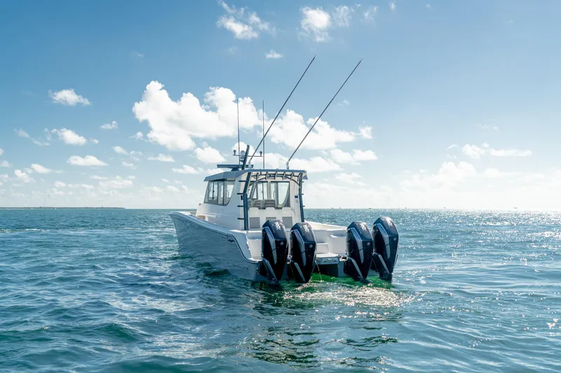 Slide: The Image of 2025 Invincible 46 Pilothouse boat with four outboard motors on open water. - 7