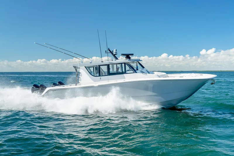 Slide: The Image of 2025 Invincible 46 Pilothouse boat cruising on open water. - 2