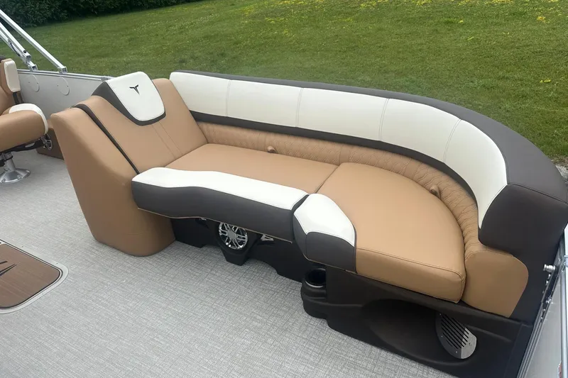Slide: The Image of Luxurious seating on 2025 Tahoe 2585 boat, featuring tan and white upholstery. - 11