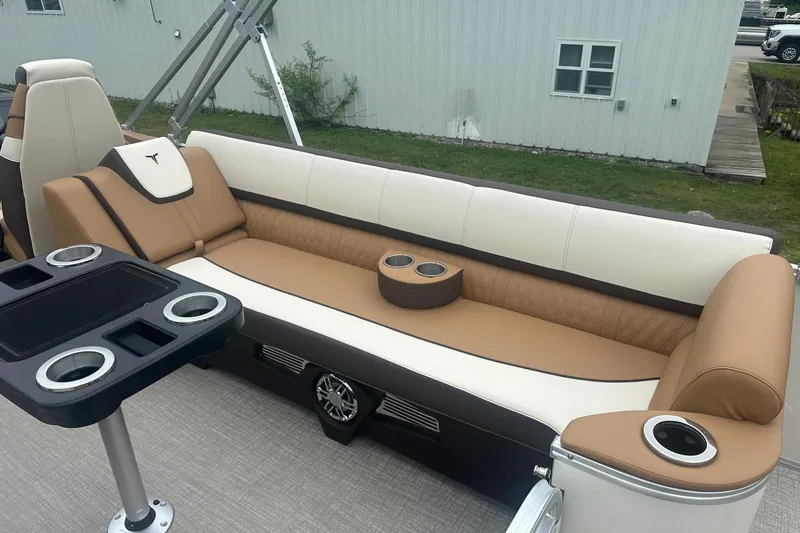 Slide: The Image of Luxurious seating on 2025 Tahoe 2585 boat with cup holders and modern design. - 13