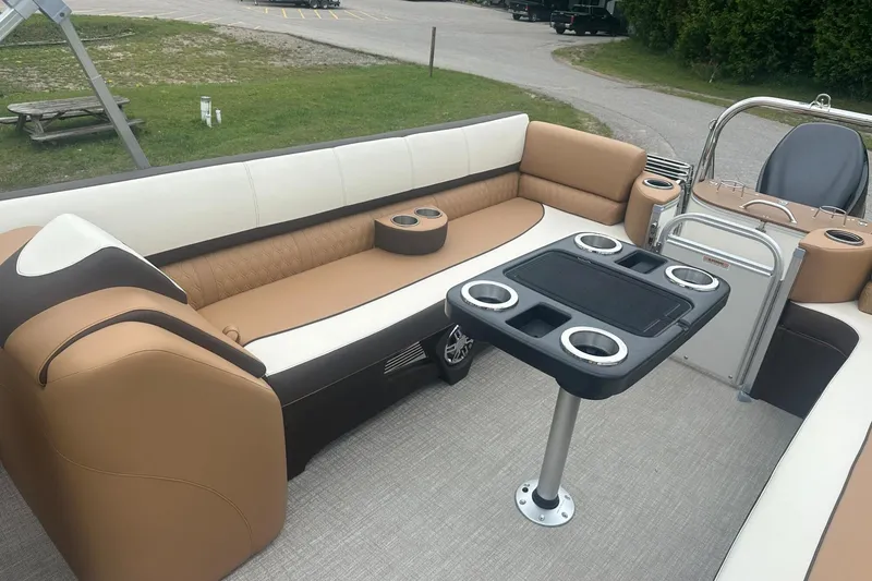 Slide: The Image of 2025 Tahoe 2585 boat interior with tan seating and a central table. - 19
