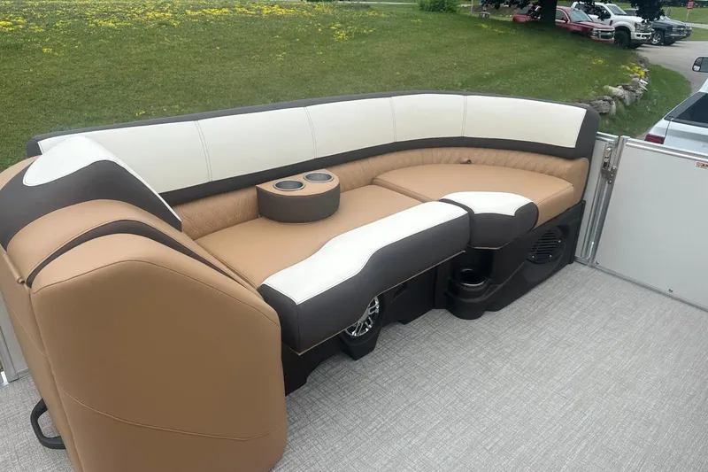 Slide: The Image of Luxurious seating on 2025 Tahoe 2585 boat, featuring tan and white upholstery with cup holders. - 20