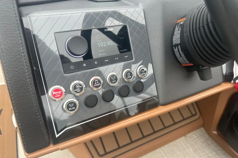 Slide: The Image of 2025 Tahoe 2585 boat dashboard with control panel and stereo system. - 22