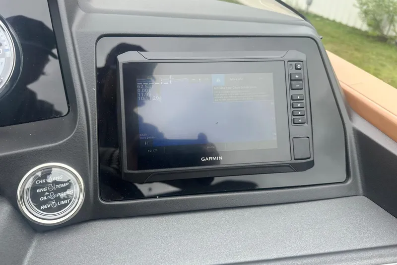 Slide: The Image of Dashboard of a 2025 Tahoe 2585 featuring a Garmin navigation system. - 24