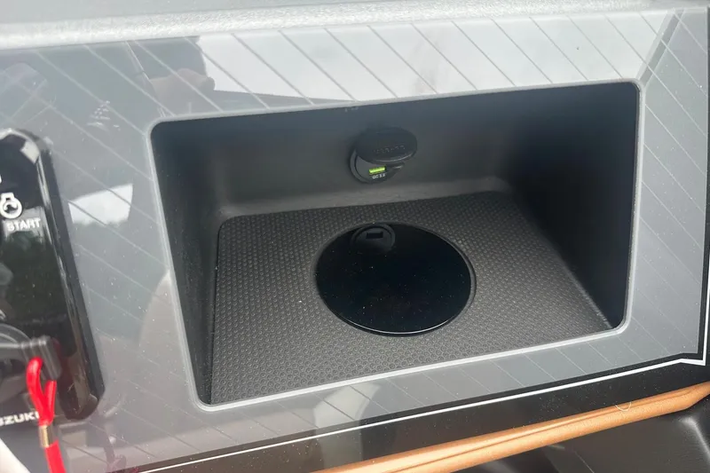 Slide: The Image of 2025 Tahoe 2585 dashboard compartment with USB port and start button. - 26