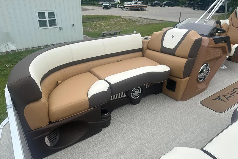 Slide: The Image of 2025 Tahoe 2585 boat interior with tan and white seating, featuring modern design and speaker system. - 27