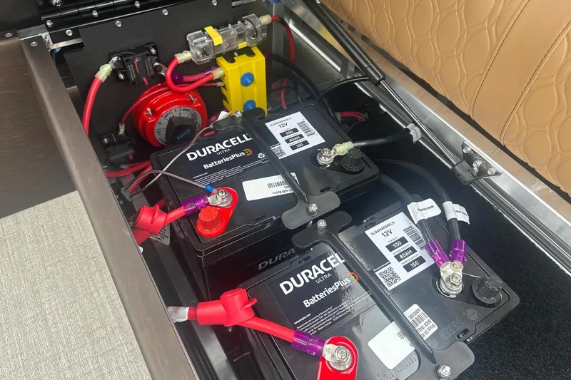 Slide: The Image of Battery compartment of a 2025 Tahoe 2585 with Duracell Ultra batteries and wiring connections. - 34