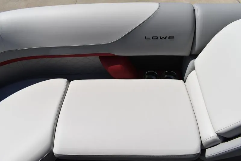Slide: The Image of 2026 Lowe SS 210 WT boat interior with white cushioned seating and cup holders. - 13