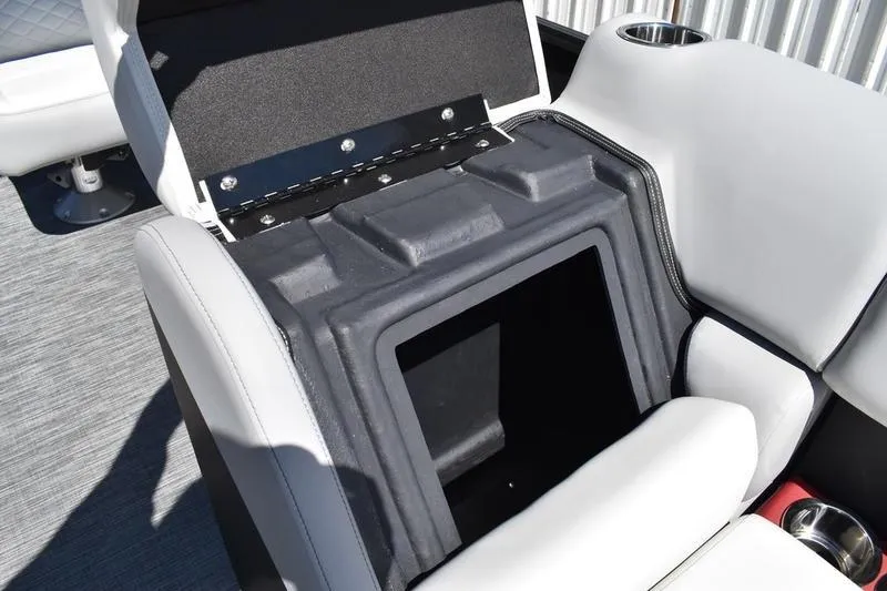 Slide: The Image of 2026 Lowe SS 210 WT boat interior with storage compartment and cup holders. - 19