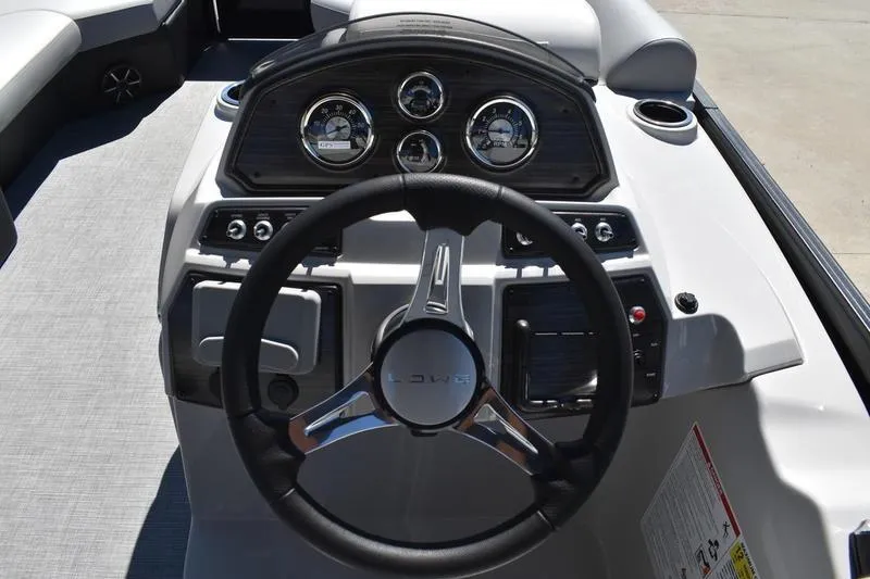 Slide: The Image of Close-up of 2026 Lowe SS 210 WT boat steering wheel and controls. - 37