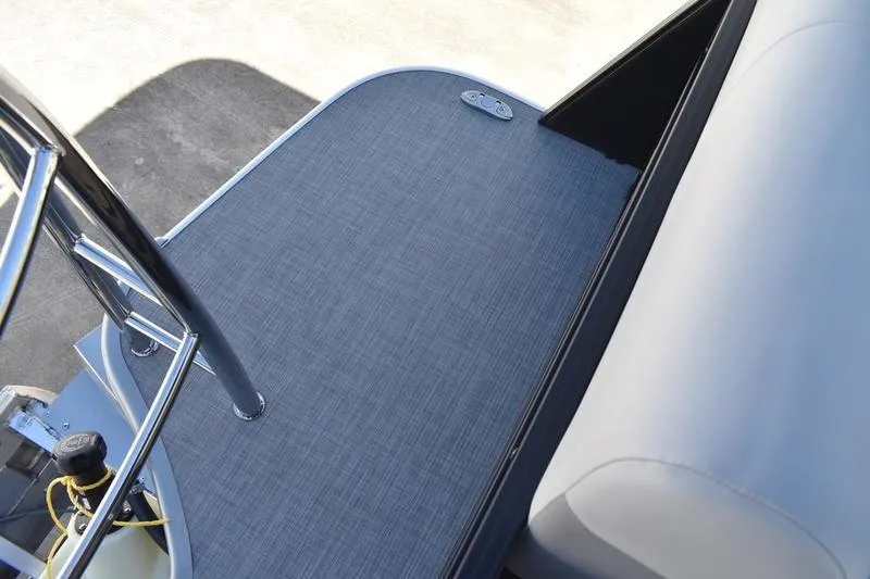 Slide: The Image of 2026 Lowe SS 210 WT pontoon boat interior with beige seating and steering console. - 56