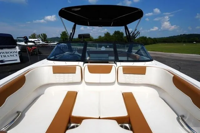 Slide: The Image of 2019 Bayliner VR5 Bowrider I/O with spacious seating and canopy, parked outdoors. - 10