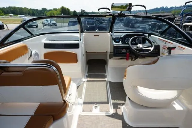 Slide: The Image of 2019 Bayliner VR5 Bowrider I/O interior with tan and white seating, steering wheel, and dashboard. - 11