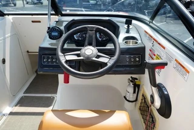 Slide: The Image of 2019 Bayliner VR5 Bowrider I/O dashboard with steering wheel and controls. - 13