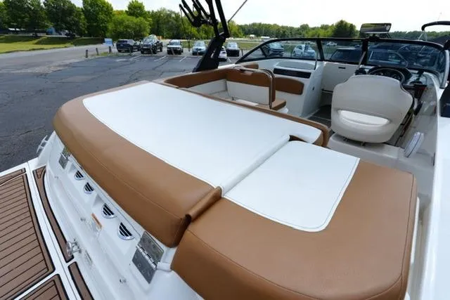 Slide: The Image of 2019 Bayliner VR5 Bowrider I/O with spacious seating and sleek design in a parking lot setting. - 16