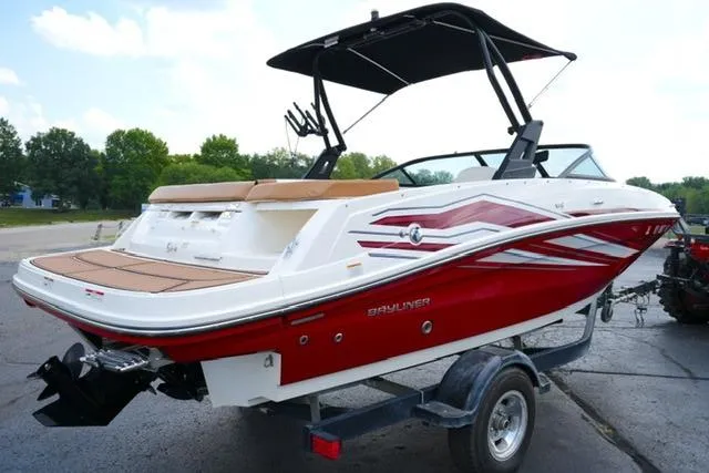 Slide: The Image of 2019 Bayliner VR5 Bowrider I/O boat with red and white design on a trailer. - 4