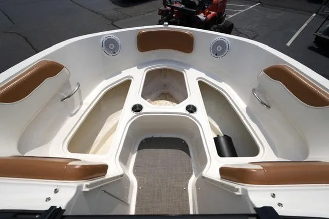 Slide: The Image of 2019 Bayliner VR5 Bowrider I/O boat interior with tan seating and storage compartments. - 9