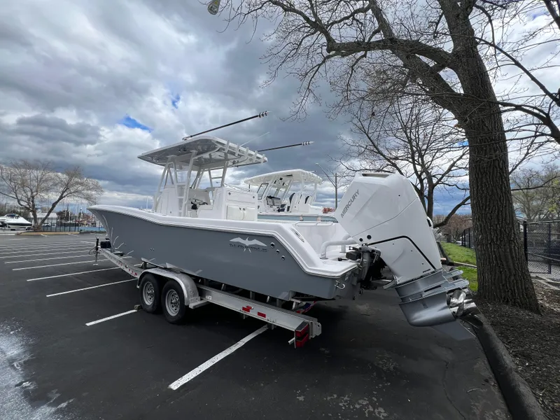 Slide: The Image of 2024 Invincible 33 Open Fisherman boat on a trailer in a parking lot. - 3