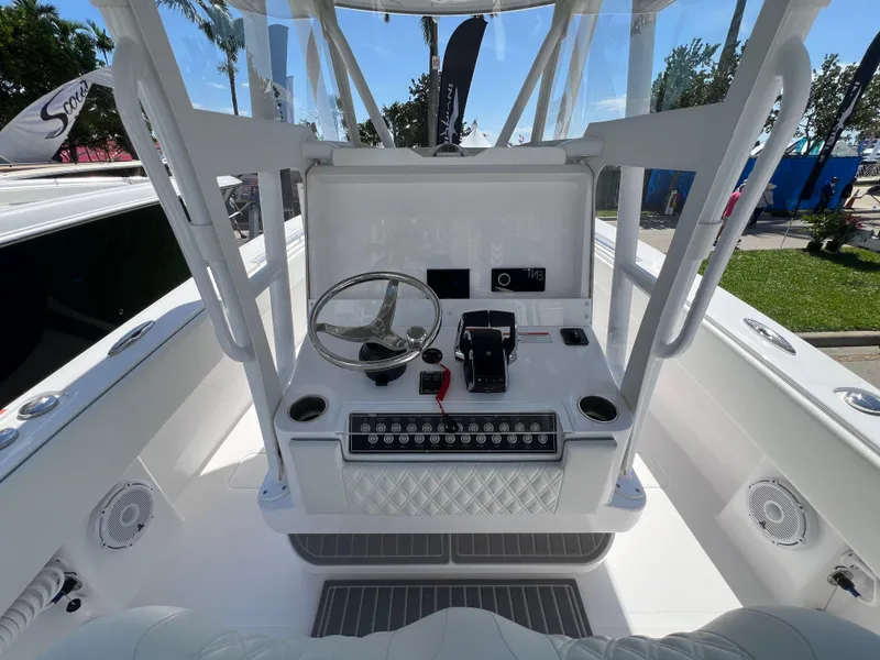 Slide: The Image of 2024 Invincible 33 Open Fisherman boat console with steering wheel and controls. - 9
