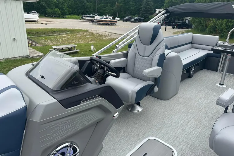 Slide: The Image of 2025 Tahoe 2585 pontoon boat interior with luxurious seating and modern helm. - 17