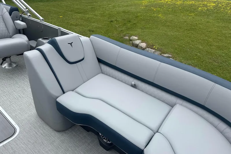 Slide: The Image of Luxurious seating on 2025 Tahoe 2585 boat, featuring sleek gray and navy upholstery. - 19