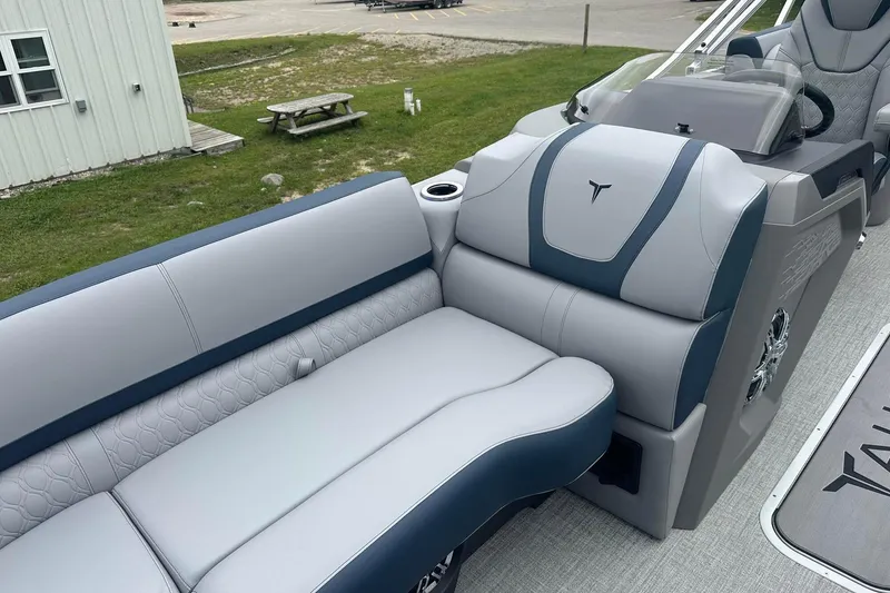 Slide: The Image of 2025 Tahoe 2585 boat interior with modern seating and steering console. - 20