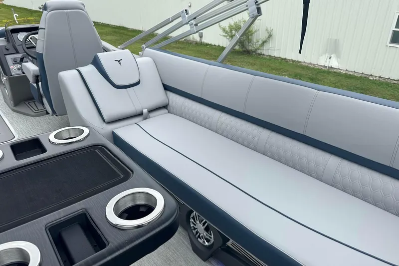 Slide: The Image of 2025 Tahoe 2585 boat interior with luxurious seating and cup holders. - 24
