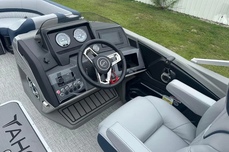 Slide: The Image of 2025 Tahoe 2585 boat dashboard with steering wheel and control panel. - 26