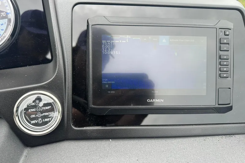 Slide: The Image of Dashboard of a 2025 Tahoe 2585 with Garmin display and engine indicators. - 29